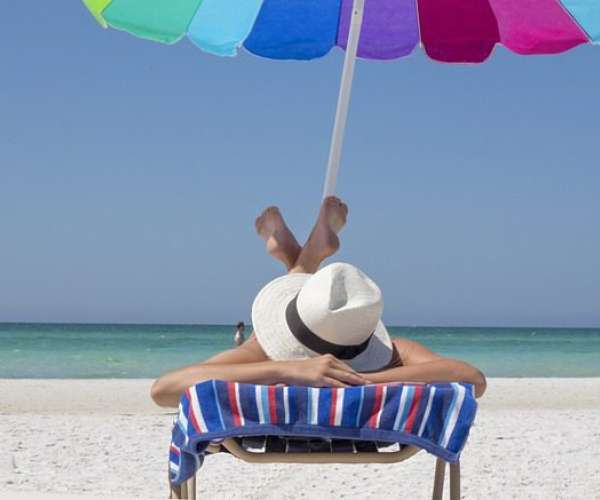 photo of a woman sunbathing on a Florida beach