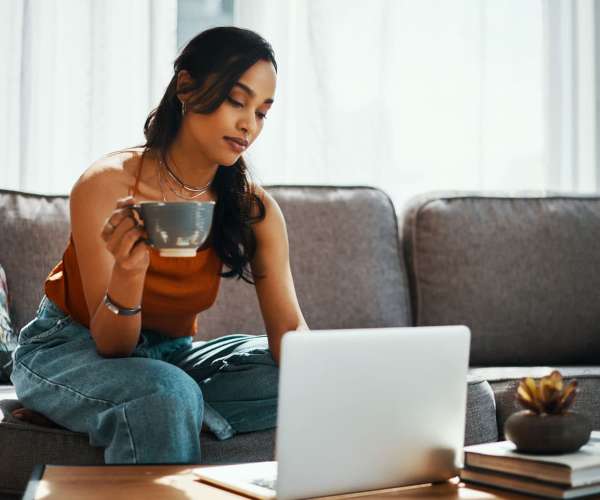 Woman looking online for car shipping cost